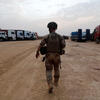 Soldier stands facing away from the camera